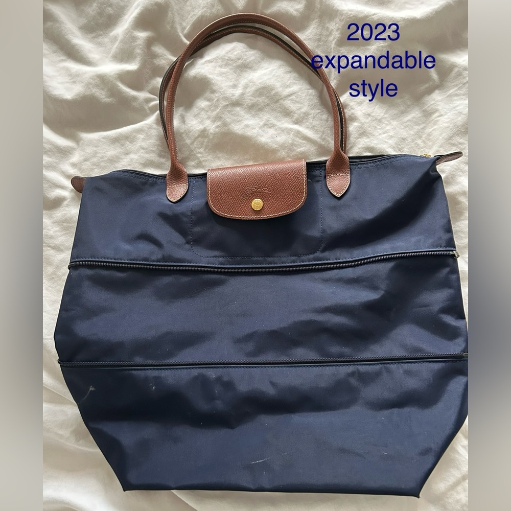 Zip inset expands/contracts,  rich brown leather trim, zip closure, snap flap